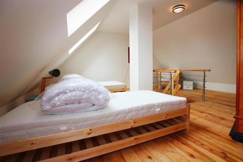 a bedroom with a bed in the attic at Holiday home in Neukalen in Neukalen