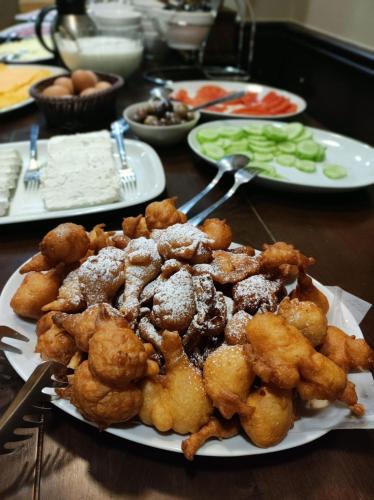 a plate of food sitting on a table with food at Hotel FAMIL - adults only in Bansko