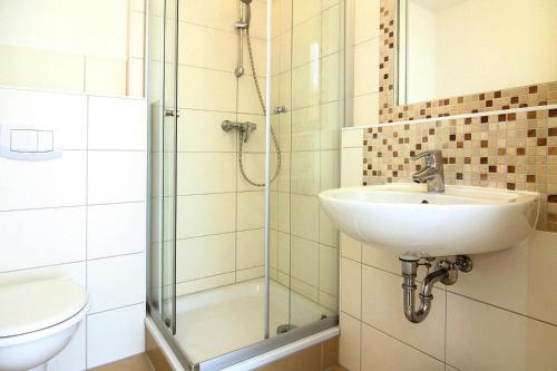 a bathroom with a sink and a shower and a toilet at Apartment, Graal-Müritz in Graal-Müritz
