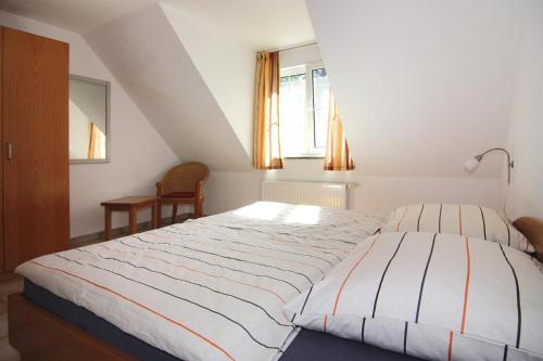 a bedroom with a bed and a window at Semi-detached house, Zingst in Zingst