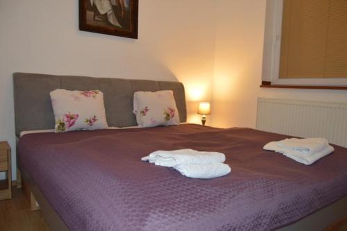 a bedroom with a bed with towels on it at Bohemica Apartman 3 in Kouřim