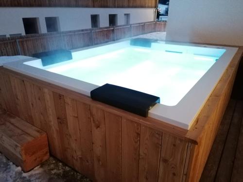 a hot tub in a building with a wooden floor at Apartments Rainer in Anterselva di Mezzo