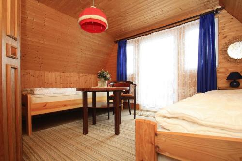 a bedroom with a bed and a table and a window at Boathouse, Teterow in Teterow