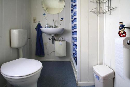 a bathroom with a white toilet and a sink at Boathouse, Teterow in Teterow