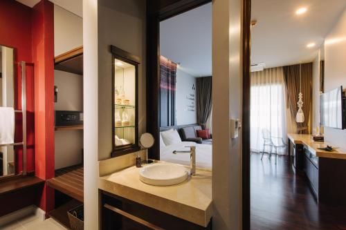 a bathroom with a sink in the middle of a room at T Heritage Hotel in Chiang Mai