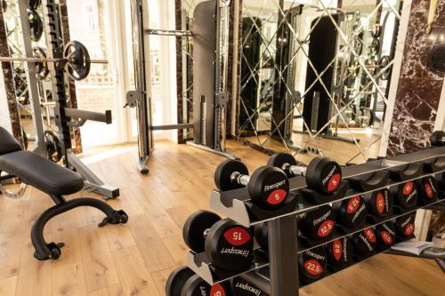 a gym with a rack of dumbbells and a mirror at Royal Palace Luxury Hotel and SPA in Khmelʼnytsʼkyy
