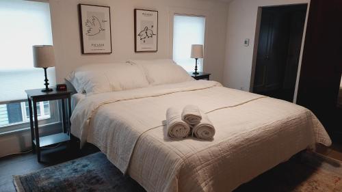 a bedroom with a bed with two towels on it at Lewisburg duplex in Lewisburg