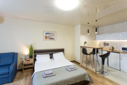 a small bedroom with a bed and a kitchen at Studio with an amazing view - 15th floor in Kharkiv