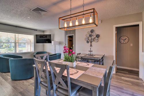a dining room and living room with a table and chairs at Modern Port St Lucie Home with Private Outdoor Oasis in River Park