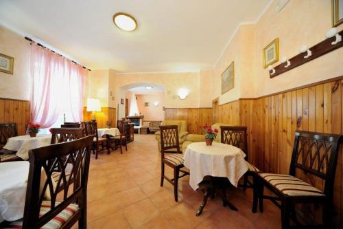 a restaurant with tables and chairs in a room at Albergo Pensione Paola in Pescasseroli