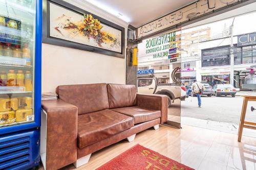 a brown leather couch sitting in a store at Hotel Lourdes la 62 in Bogotá