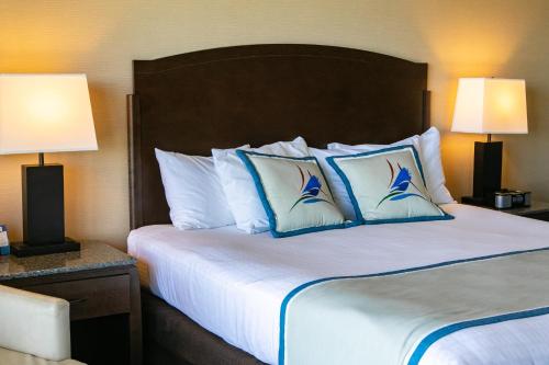 a hotel room with a bed with blue and white pillows at Swinomish Casino & Lodge in Anacortes