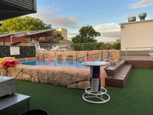 a pool with a table in the middle of a yard at MOM Darwin in Darwin