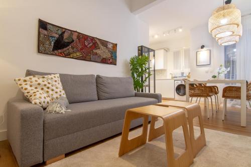 a living room with a couch and a table at Bilbao Heart 2BDR Apartment - Parking privado opcional in Bilbao