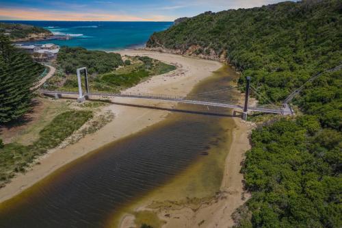 an aerial view of a bridge over a beach at The Great Ocean Road Studios in Port Campbell