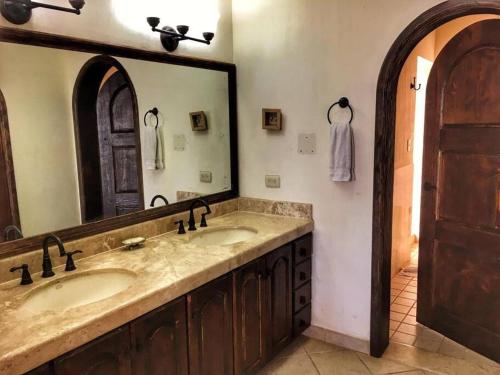 a bathroom with two sinks and a large mirror at Gorgeous Beachfront Villa Rocky point, Sandy Beach in Puerto Peñasco