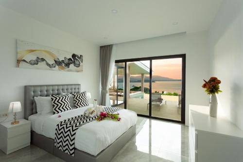 a bedroom with a bed and a view of the ocean at Michael villa in Koh Samui