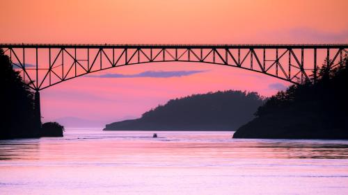 a bridge over a body of water at sunset at Swinomish Casino & Lodge in Anacortes