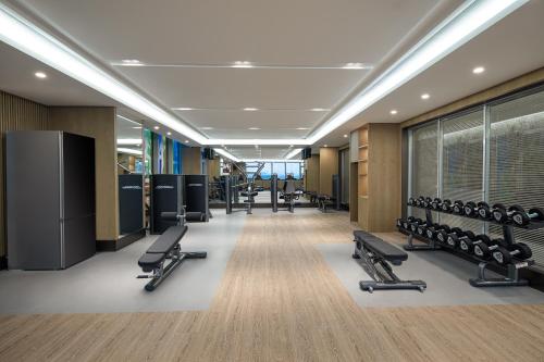 a gym with a row of chairs and weights at Ascott New District Wuxi in Wuxi