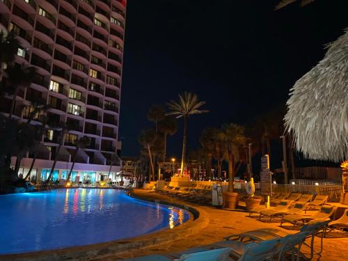 a hotel with a swimming pool at night at Holiday Inn Resort Panama City Beach - Beachfront, an IHG Hotel in Panama City Beach