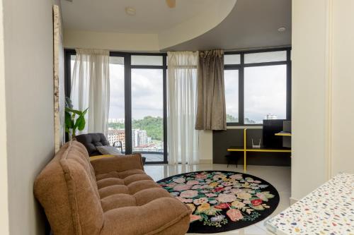 a living room with a chair and a rug at ArteS Suite Penang, by HOMEY in George Town