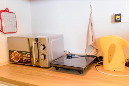 a toaster oven sitting on top of a counter at ArteS Suite Penang, by HOMEY in George Town