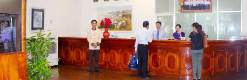 a group of people standing at a bar at Đồi Dương Hotel in Phan Thiet