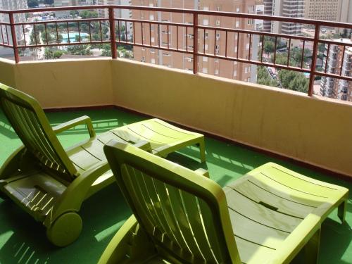 two chairs sitting on top of a balcony at Los Olivos - Zand Properties in Benidorm