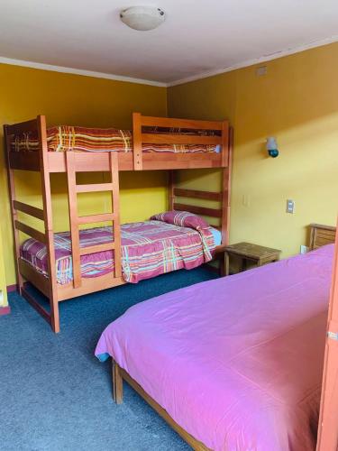 a bedroom with two bunk beds and a bed at Hospedaje in Osorno