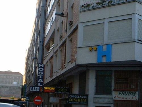a large building with a sign on the side of it at Hostal Liebana in Santander