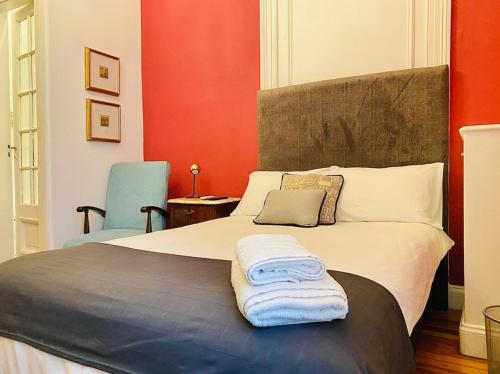 a bed with a white comforter and pillows on it at Hotel Chemin in Buenos Aires