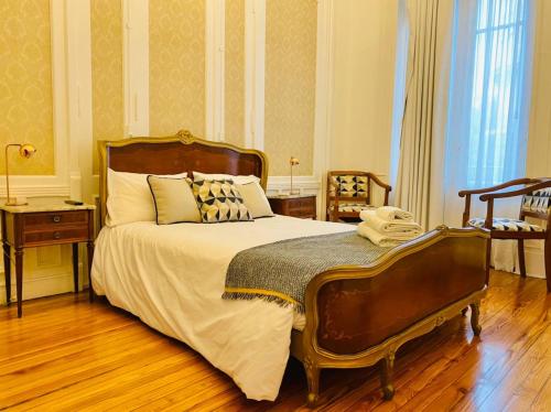 a bedroom with a large bed and a wooden floor at Hotel Chemin in Buenos Aires