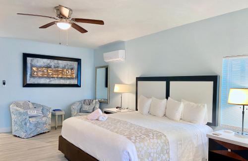 a bedroom with a bed and a ceiling fan at Organic Beach Retreat in Daytona Beach