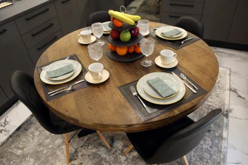 a wooden table with a bowl of fruit on it at LA Larissa Luxury Apartments Kreousa in Larisa