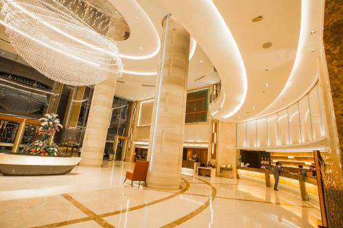 a lobby of a shopping mall with a christmas tree at The Grand Fourwings Convention Hotel Bangkok in Bangkok