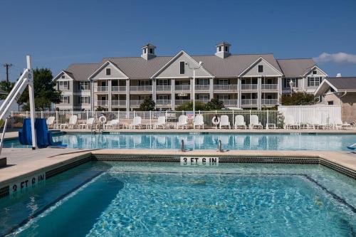 a swimming pool in front of a resort at Holiday Inn Club Vacations Hill Country Resort at Canyon Lake in Canyon Lake
