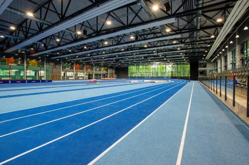 a large indoor tennis court in a building at Stadium Hotel in Valmiera
