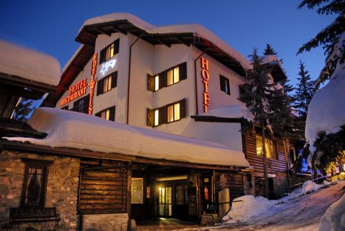 a large building with snow on the side of it at Hotel Edelweiss & SPA in Cesana Torinese