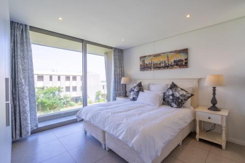 Katil atau katil-katil dalam bilik di Stunning & Modern Apartment in Oceandune