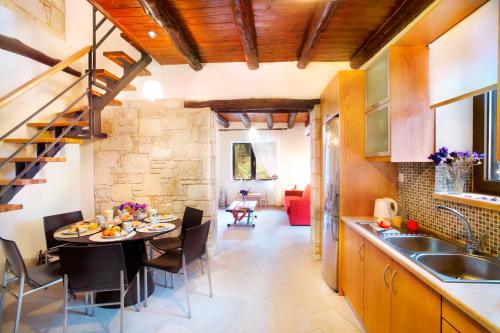 a kitchen and dining room with a table and chairs at Villa Zourva in Zoúrva