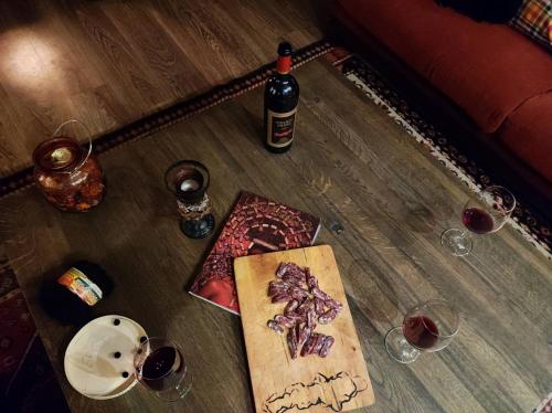 a table with a bottle of wine and glasses on it at Hotel FAMIL - adults only in Bansko
