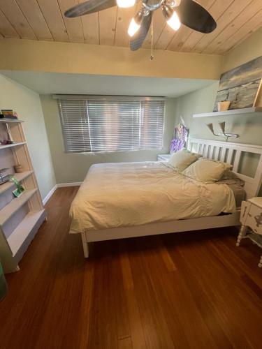 a bedroom with a bed and a ceiling fan at 3 BR Channel House with Dock in Lakeport
