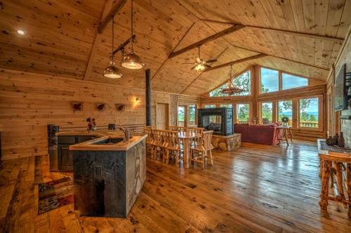 an open kitchen and living room of a log cabin at Serenity Peak in Blue Ridge