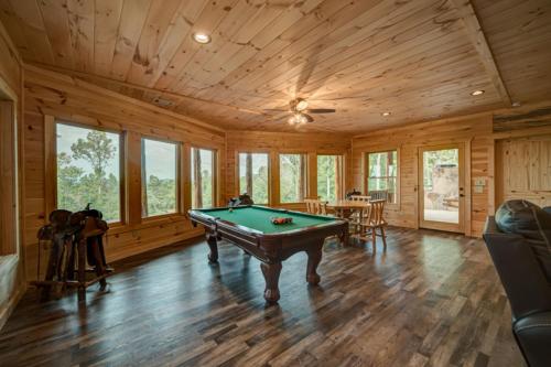 a pool table in a room with wooden walls at Serenity Peak in Blue Ridge