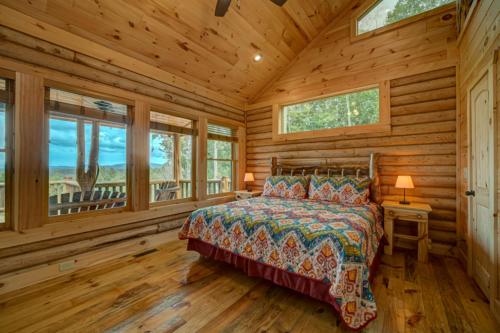 a bedroom with a bed in a log cabin at Serenity Peak in Blue Ridge