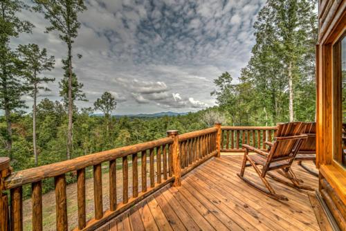 a wooden deck with a bench on top of it at Serenity Peak in Blue Ridge