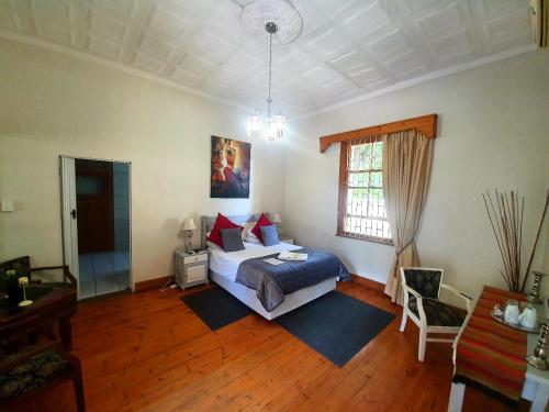 A bed or beds in a room at Castello Guesthouse Vryburg