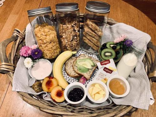 a basket filled with different types of breakfast foods at Aranui Farmstay in Waitomo Caves