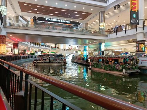 a shopping mall with boats in the water at Astetica Residences @ Seri Kembangan in Seri Kembangan