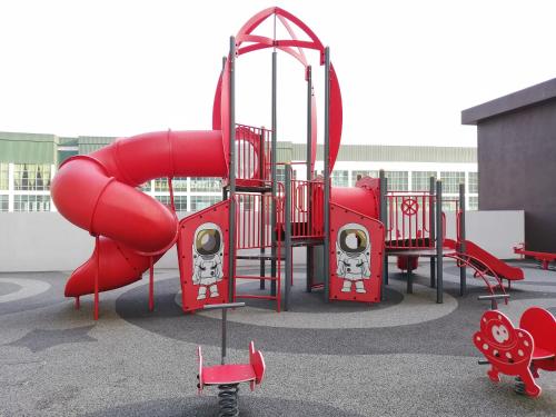 a playground with a red slide in a parking lot at Astetica Residences @ Seri Kembangan in Seri Kembangan